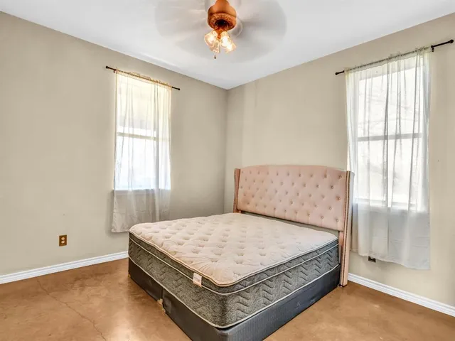 a bedroom with a bed and window