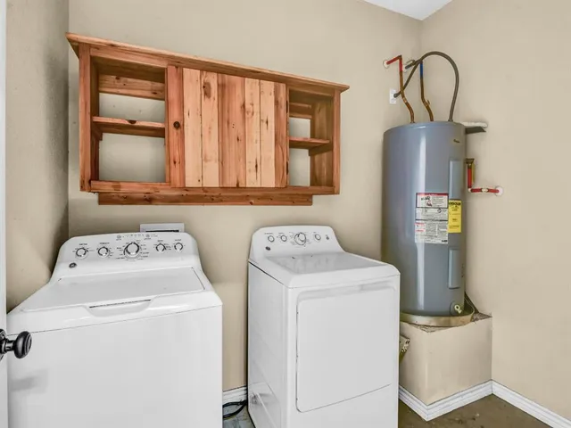a view of storage and utility room with washer and dryer