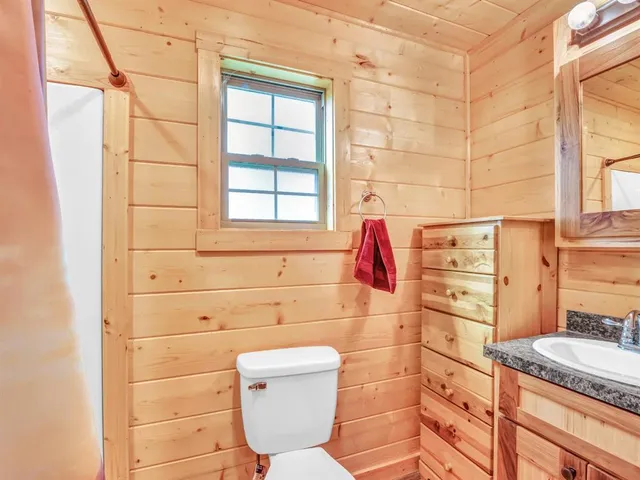 a bathroom with a granite countertop toilet sink and shower
