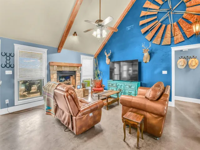 a living room with furniture a ceiling fan and a window