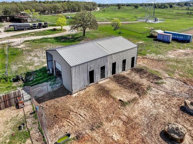 a aerial view of a house with a yard table and chairs