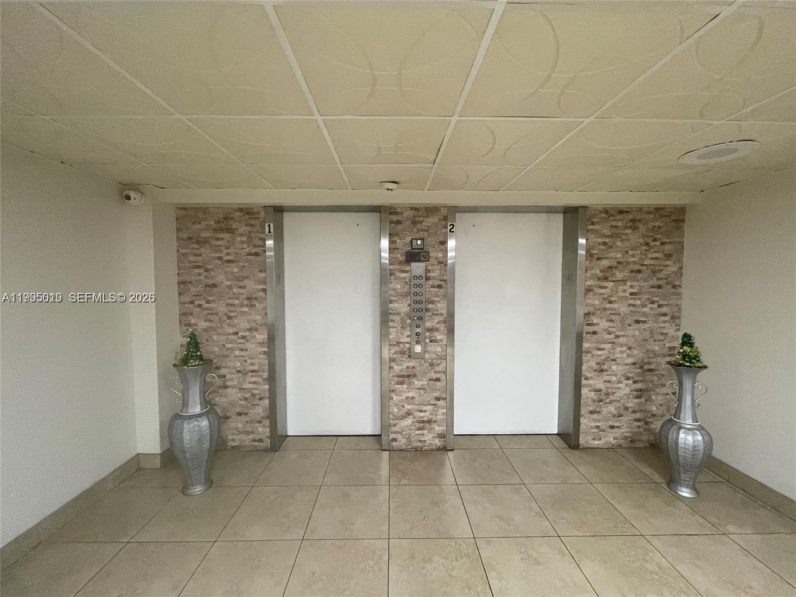 777 Southwest 9th Avenue, Unit 411 Miami, FL 33130 - Photo 13 of 14 a view of an empty room with a brick wall and a window