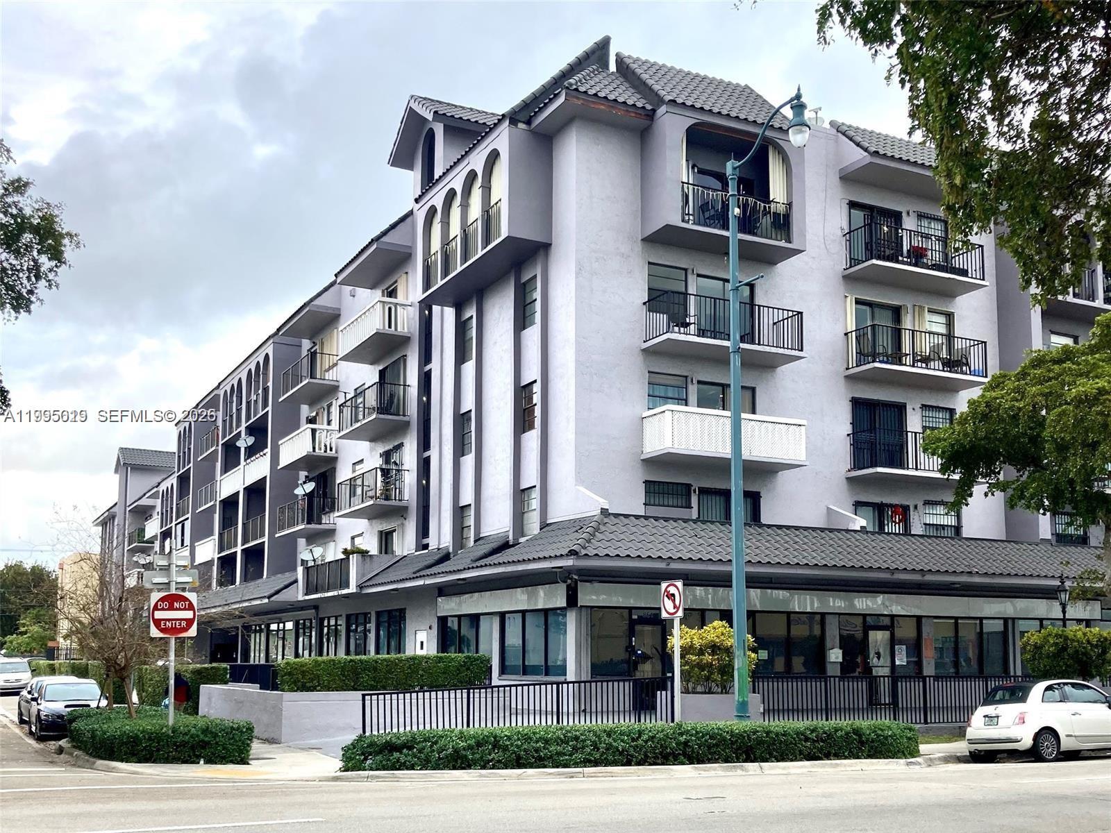 777 Southwest 9th Avenue, Unit 411 Miami, FL 33130 - Photo 2 of 14 a front view of an apartment building with a yard