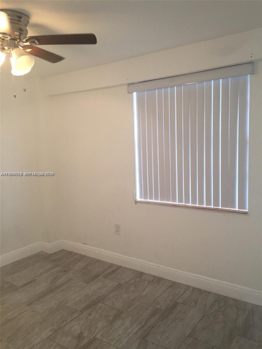 777 Southwest 9th Avenue, Unit 411 Miami, FL 33130 - Photo 9 of 14 a view of a small space with wooden floor and a window