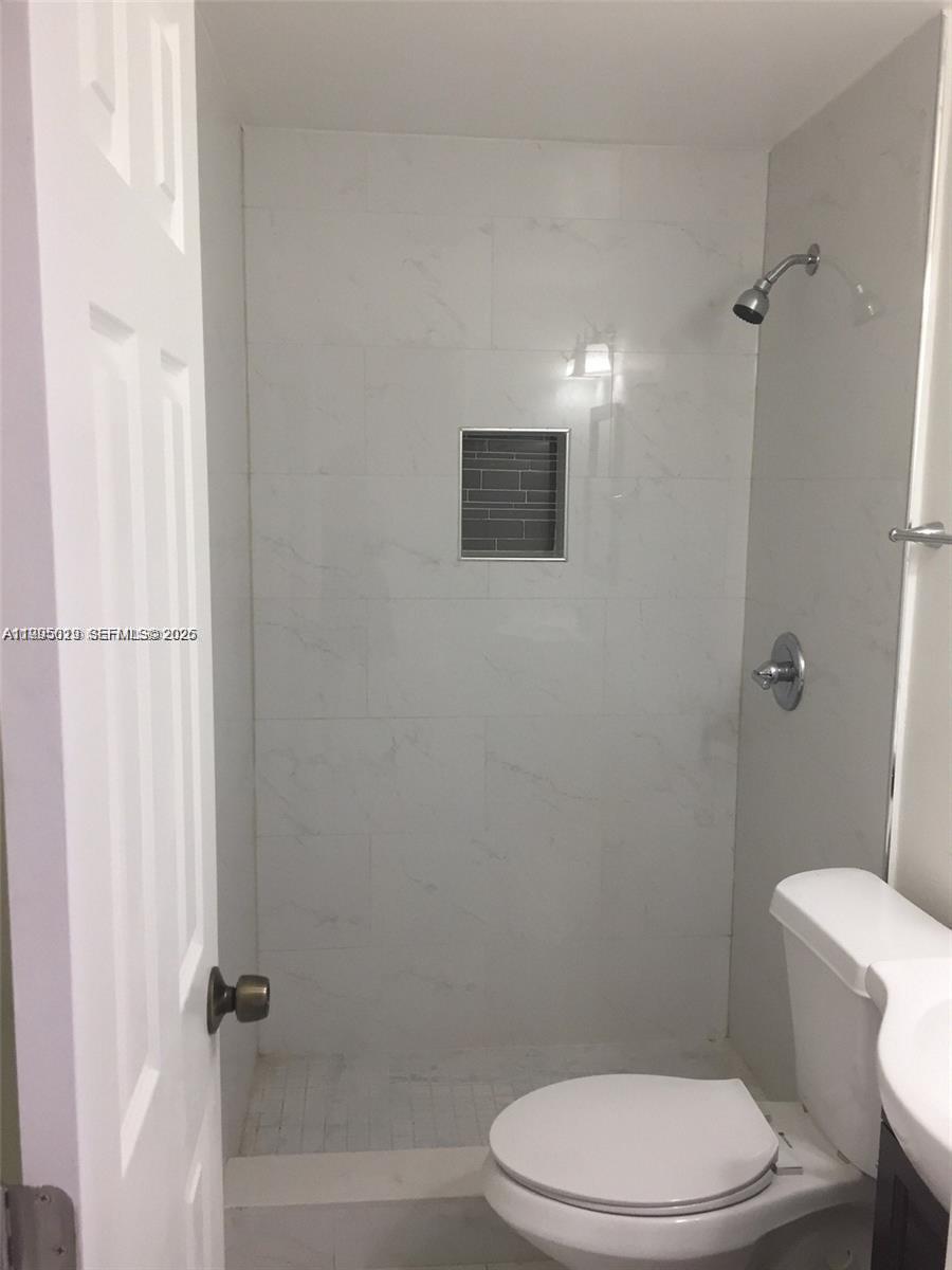 777 Southwest 9th Avenue, Unit 411 Miami, FL 33130 - Photo 10 of 14 a white toilet sitting next to a bath tub