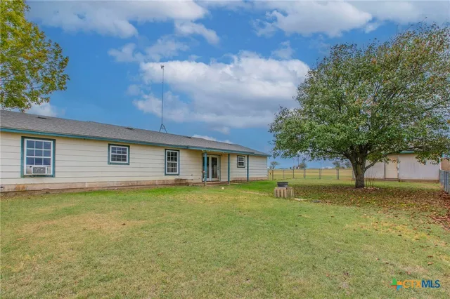 a front view of house with yard and trees