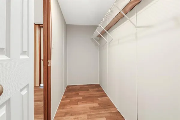 a view of a hallway with wooden floor and entryway