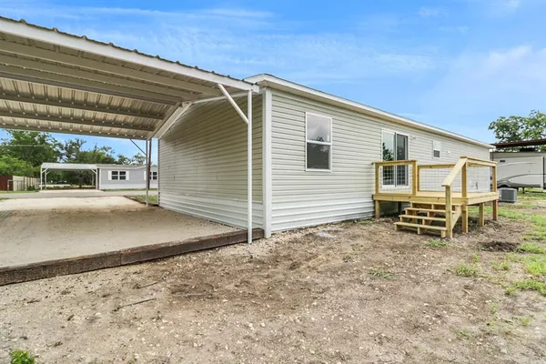 a view of a house with a wooden fence