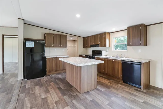 a kitchen with a sink and a stove top oven