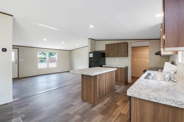 a kitchen with stainless steel appliances granite countertop a sink stove and refrigerator