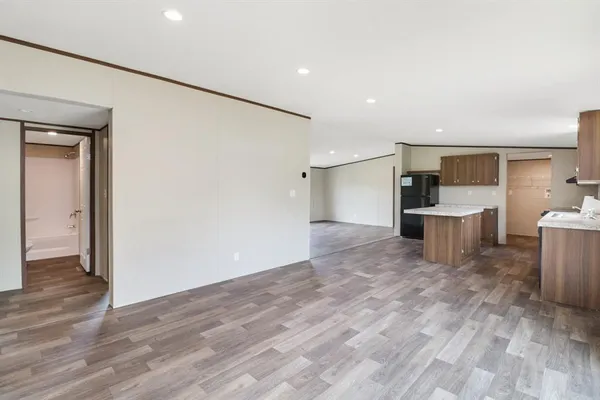 a view of a kitchen with a refrigerator and a sink
