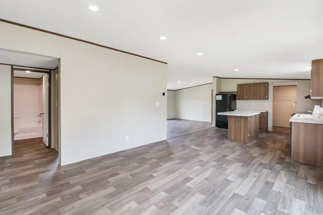 a view of a kitchen with a refrigerator and a sink