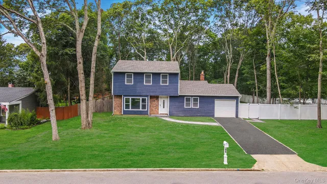 a view of a house with a yard deck and a small cabin