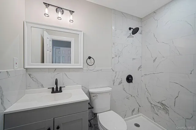 a bathroom with a sink a toilet and a mirror