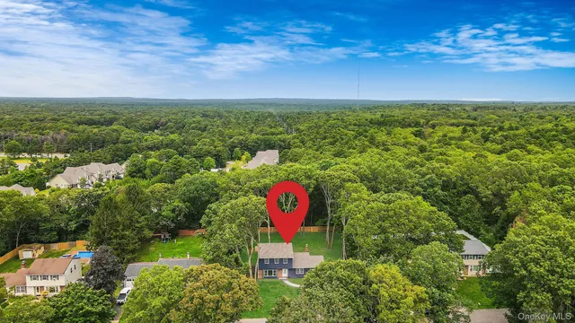 an aerial view of a house with a yard basket ball court and outdoor seating