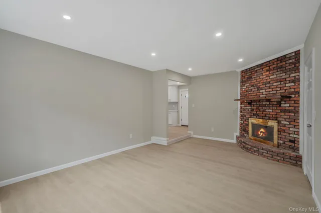 a view of an empty room with a fireplace