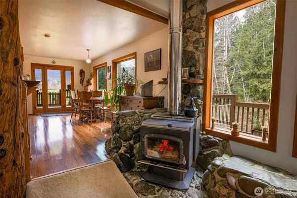 a living room with furniture a fireplace and a floor to ceiling window