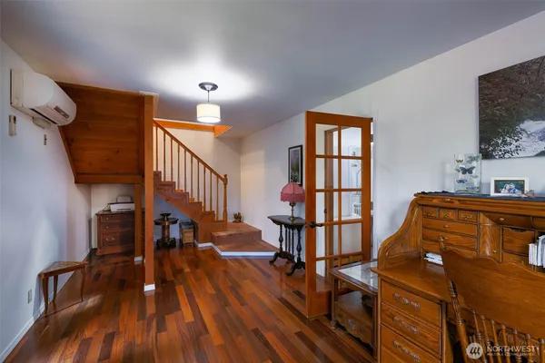 a view of a livingroom with furniture and hardwood floor