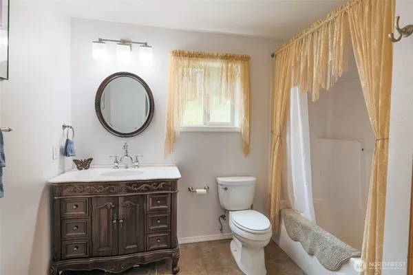 a bathroom with a toilet a sink and a mirror