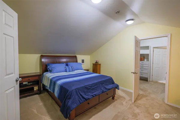 a bedroom with a bed and a view of bathroom