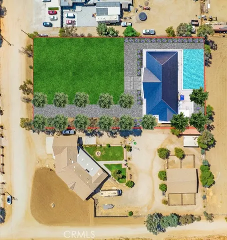 an aerial view of a house with a garden and houses