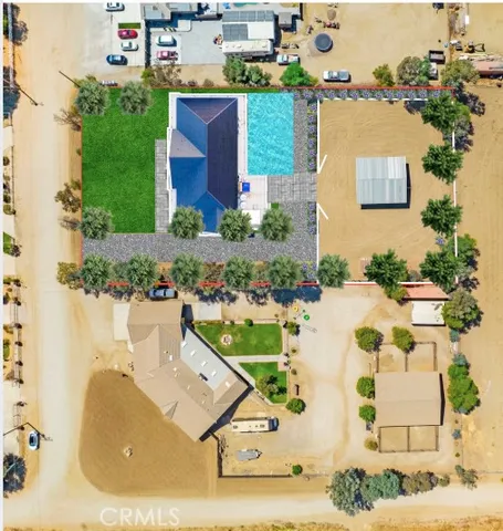 an aerial view of a house with a yard and lake view