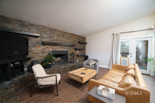 313 East Haloid Avenue Ridgecrest, CA 93555 - Photo 14 of 39 a living room with furniture a flat screen tv and a fireplace