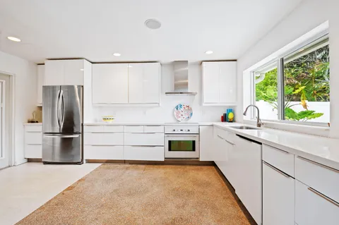 a kitchen with a stove a refrigerator and a sink