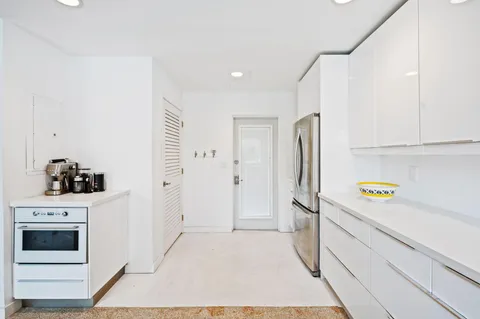 a kitchen with a refrigerator sink and stove