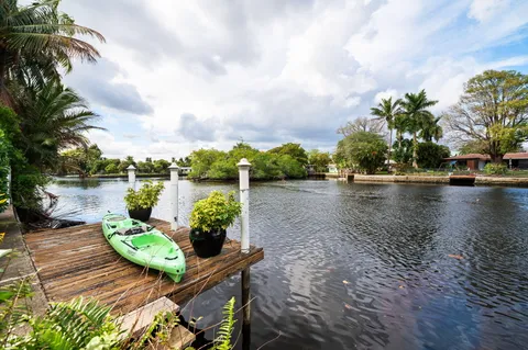 a view of a lake with couches and wooden floor