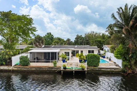 an aerial view of a house with a lake view