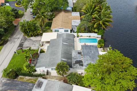 an aerial view of residential houses with outdoor space and lake view