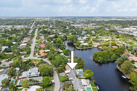 an aerial view of residential houses with outdoor space and trees