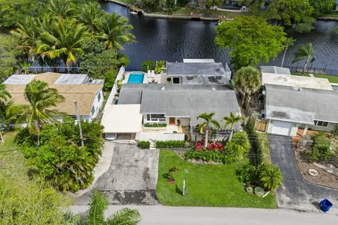an aerial view of a house with a yard
