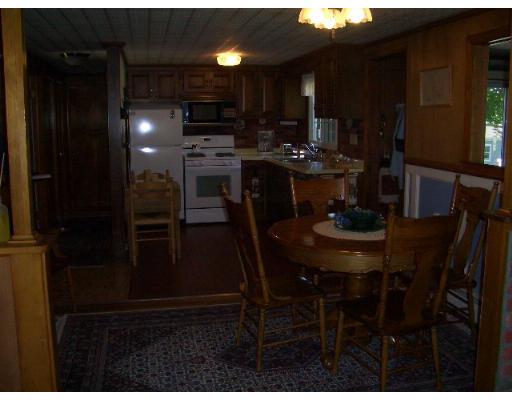 15 Rounseville Road Rochester, MA 02770 - Photo 3 of 15 a kitchen with a table chairs and a refrigerator