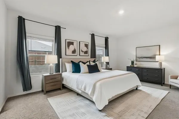 a bedroom with a large bed and a chandelier