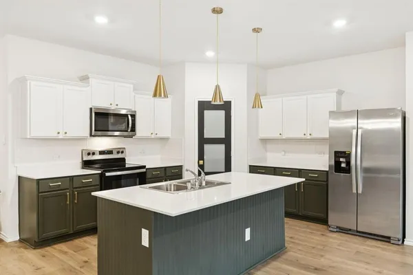 a kitchen with a sink and stainless steel appliances