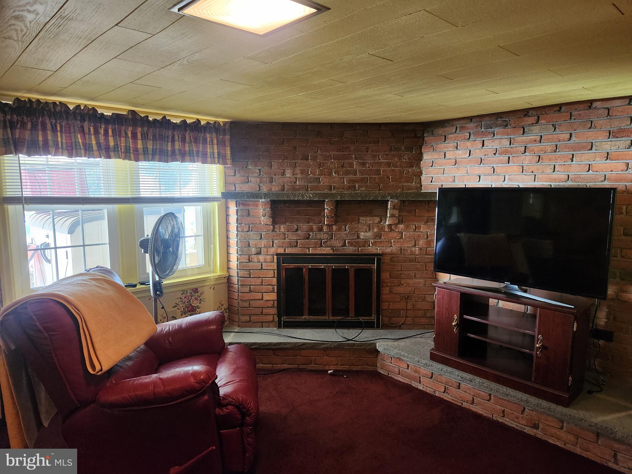 444 Donegal Springs Road Mount Joy, PA 17552 - Photo 3 of 29 a living room with furniture a flat screen tv and a fireplace