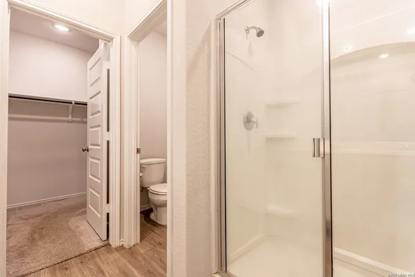 a bathroom with a shower and a toilet
