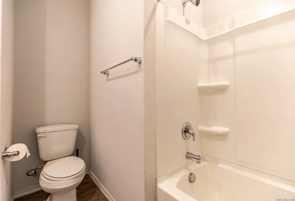 a white toilet sitting next to a bathroom sink and vanity