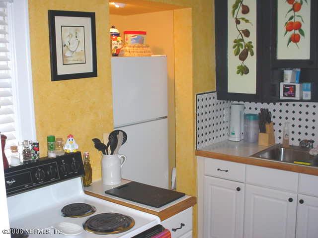 4824 Manchester Road Jacksonville, FL 32210 - Photo 2 of 10 a kitchen with a sink and a stove with wooden floor