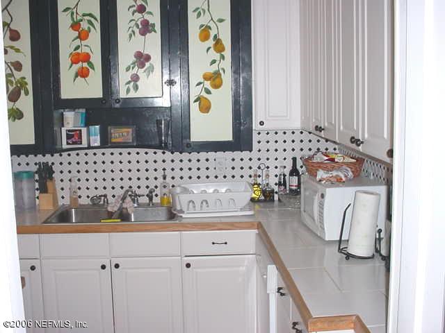 4824 Manchester Road Jacksonville, FL 32210 - Photo 4 of 10 a bathroom with a sink and a mirror