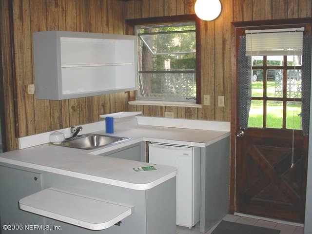 4824 Manchester Road Jacksonville, FL 32210 - Photo 10 of 10 a bathroom with a sink and a mirror