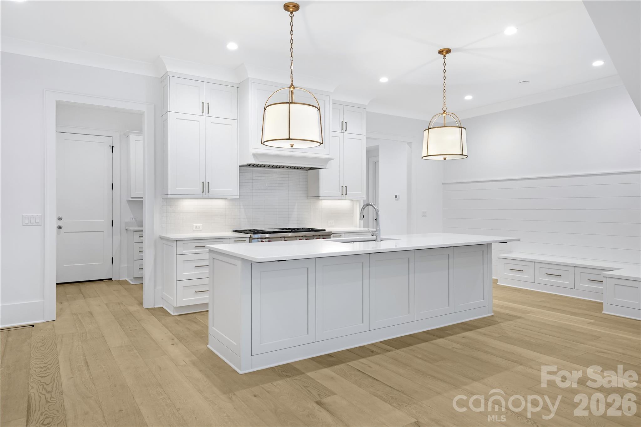 5035 Gilchrist Road, Unit 1B Charlotte, NC 28211 - Photo 11 of 46 a kitchen with stainless steel appliances granite countertop a sink a stove and a wooden floors