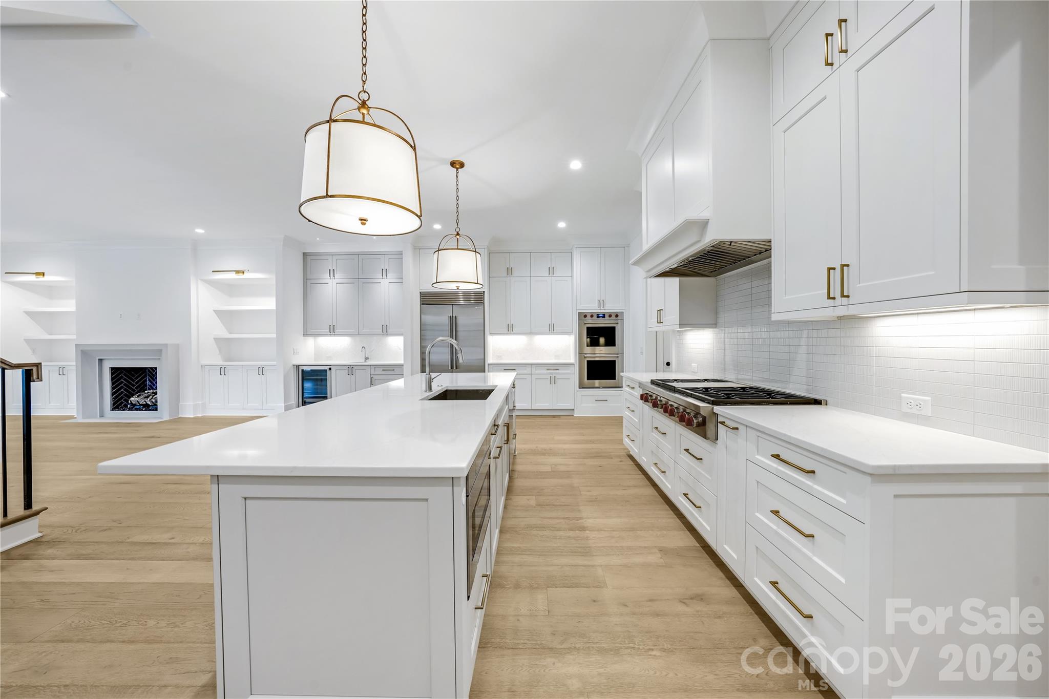 5035 Gilchrist Road, Unit 1B Charlotte, NC 28211 - Photo 12 of 46 a large kitchen with stainless steel appliances kitchen island a stove a sink a refrigerator and a granite counter tops