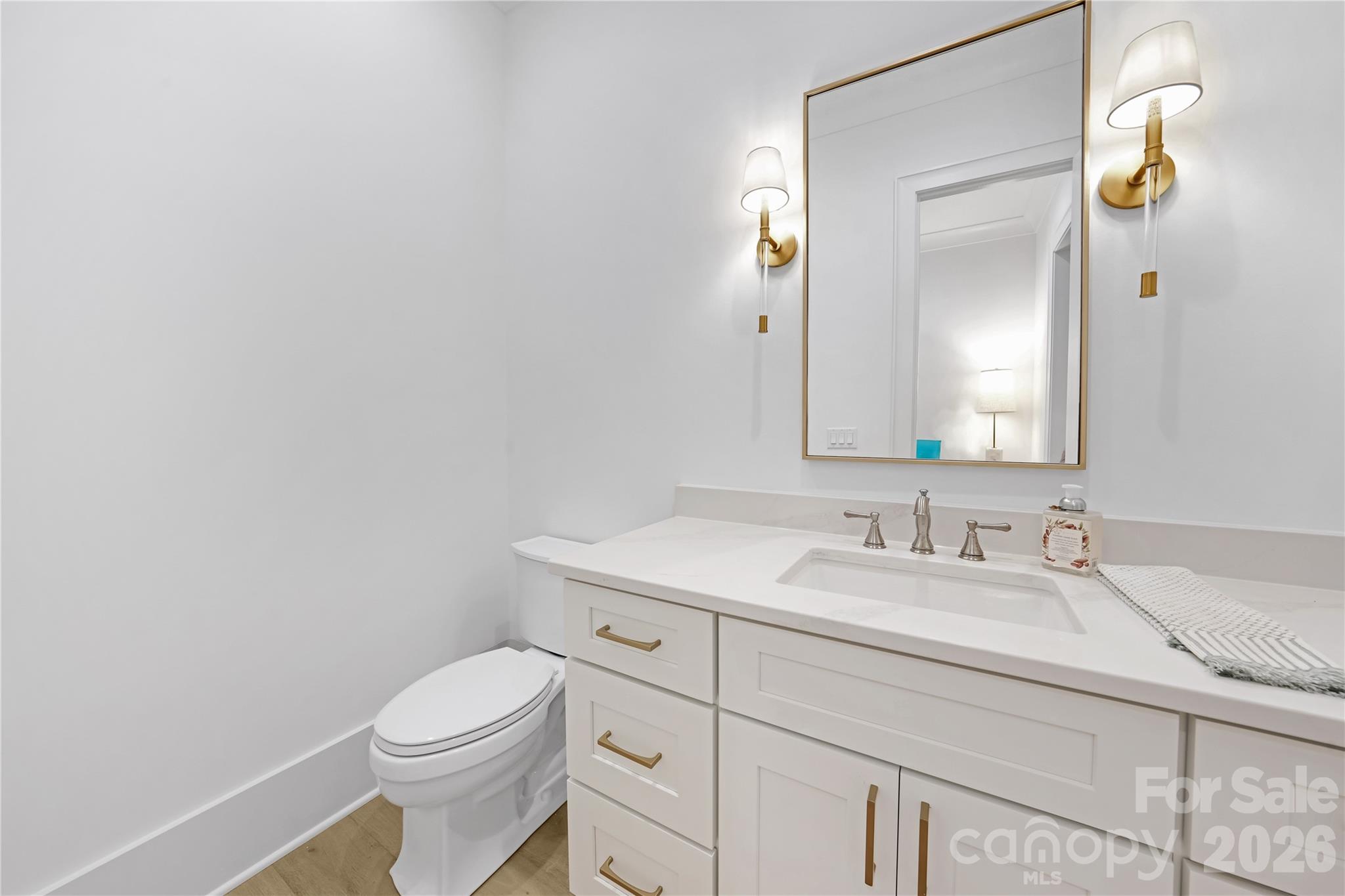 5035 Gilchrist Road, Unit 1B Charlotte, NC 28211 - Photo 24 of 46 a bathroom with a toilet sink vanity and mirror