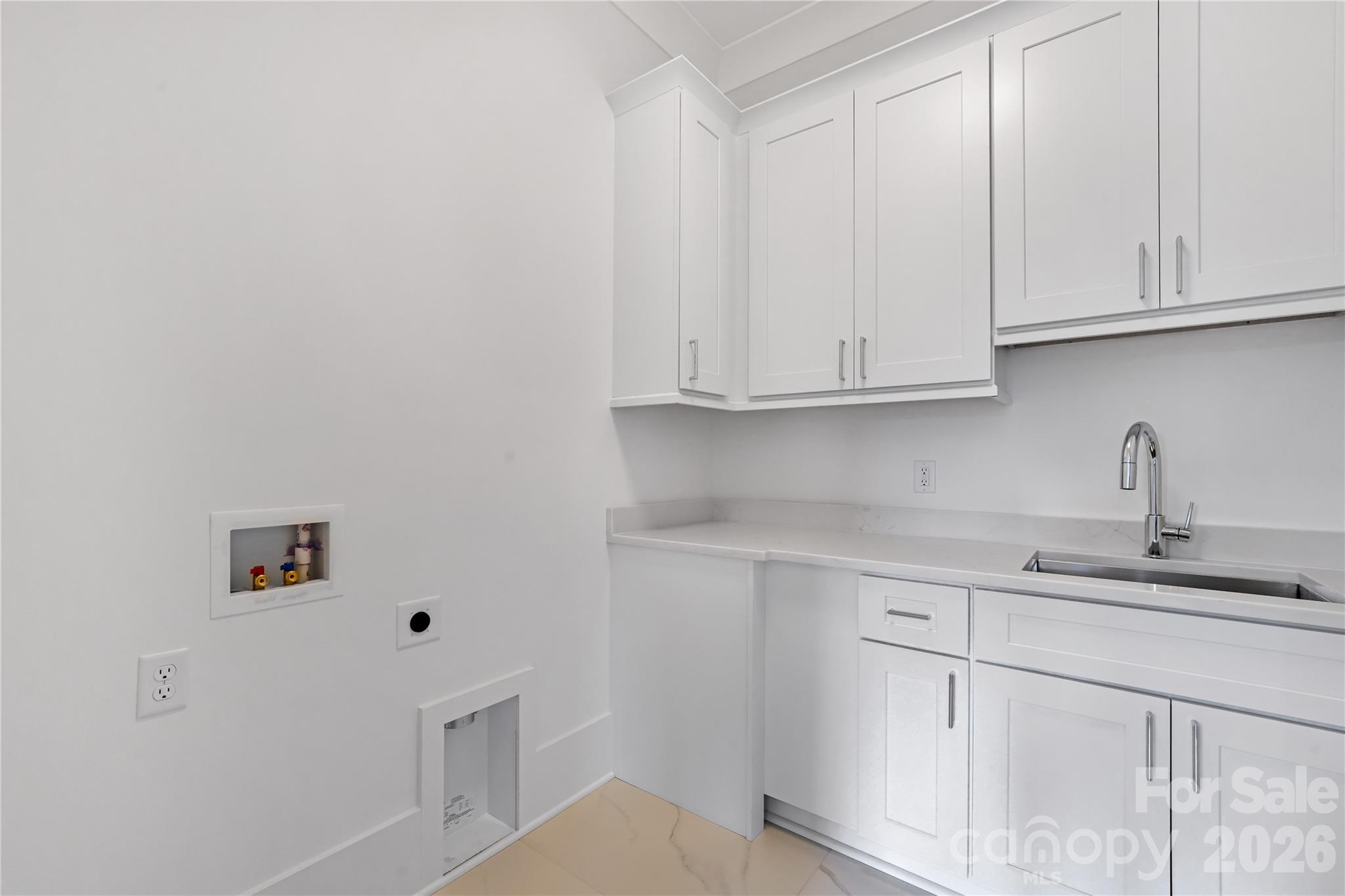 5035 Gilchrist Road, Unit 1B Charlotte, NC 28211 - Photo 40 of 46 a kitchen with white cabinets