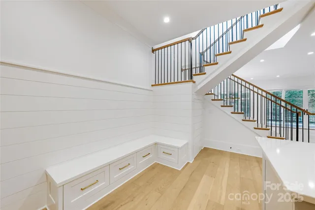 a view of a room with wooden floor and staircase