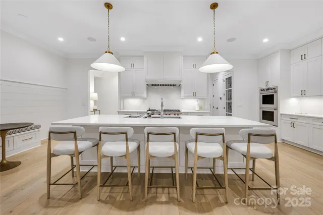 a kitchen with a dining table a sink and cabinets