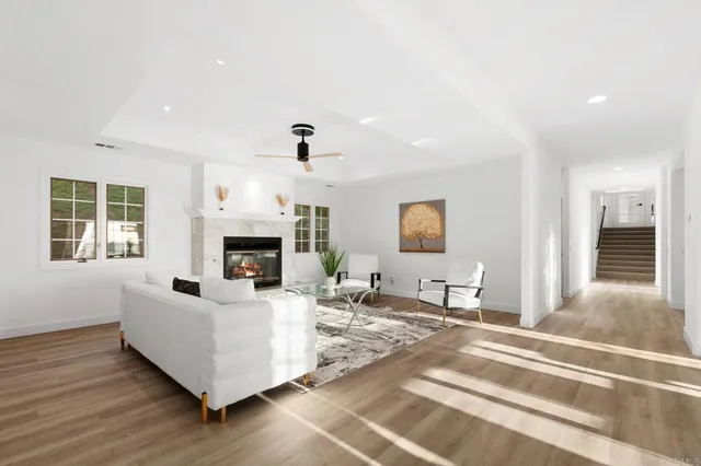 a large white kitchen with a sink and dishwasher with white cabinets